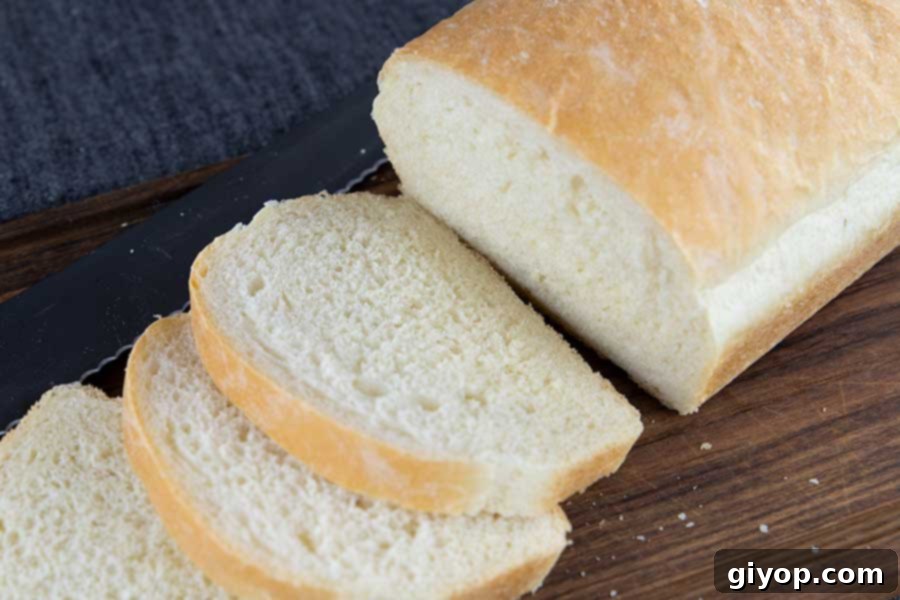 White bread sliced on a wooden cutting board.