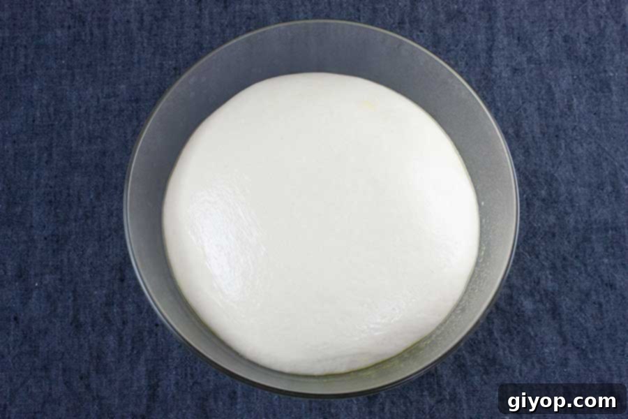 Dough in a glass bowl.