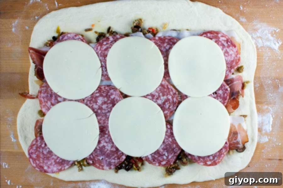 Muffuletta spirals. Bread dough spread out with meats and cheeses