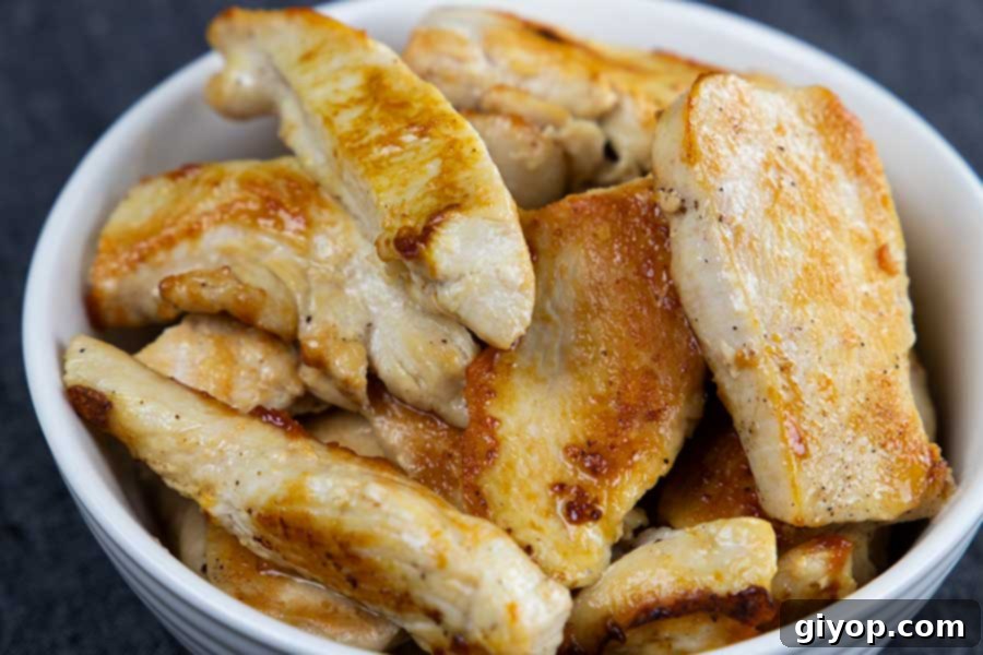 Delicious Gluten Free Chicken Fajita Stew 4 Perfectly browned chicken strips resting in a bowl, ready to be added back into the flavorful fajita stew.