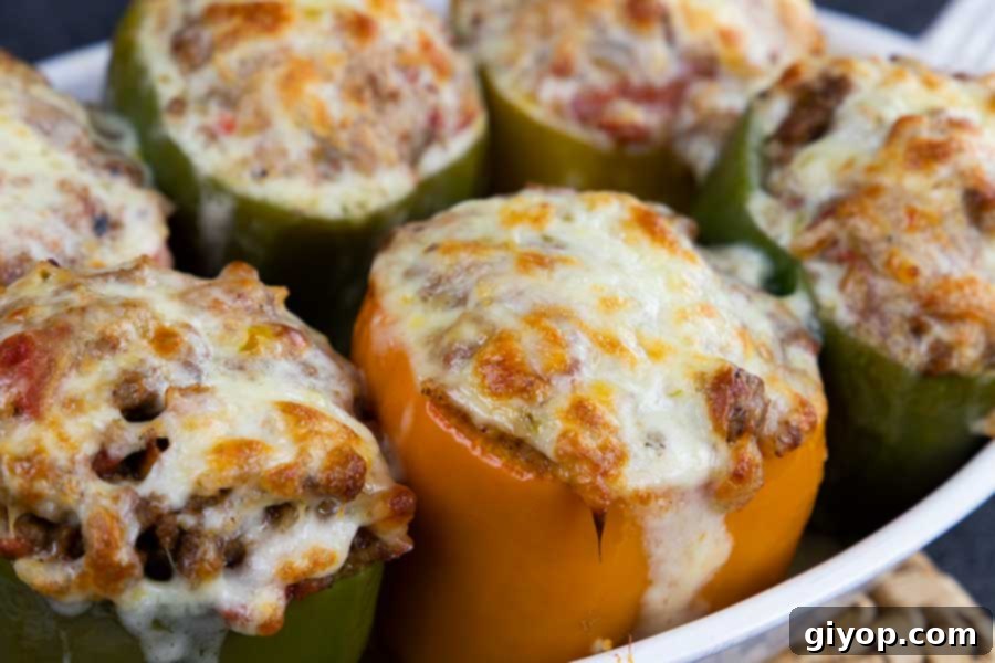 Stuffed bell peppers in a white baking dish.