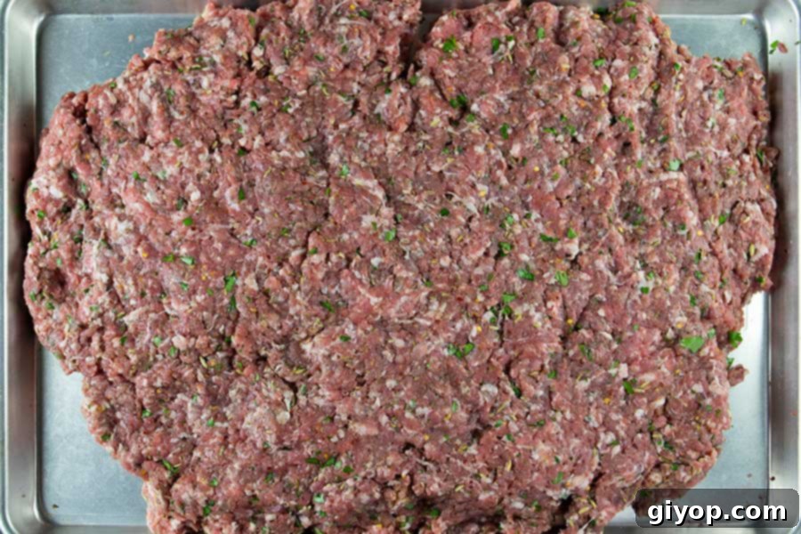 Mixed Italian sausage on a baking sheet.