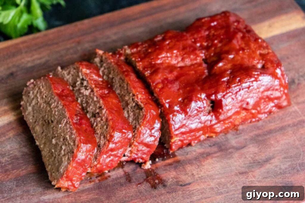 Slow-Smoked Meatloaf Masterpiece 2 Smoked meatloaf on a cutting board.