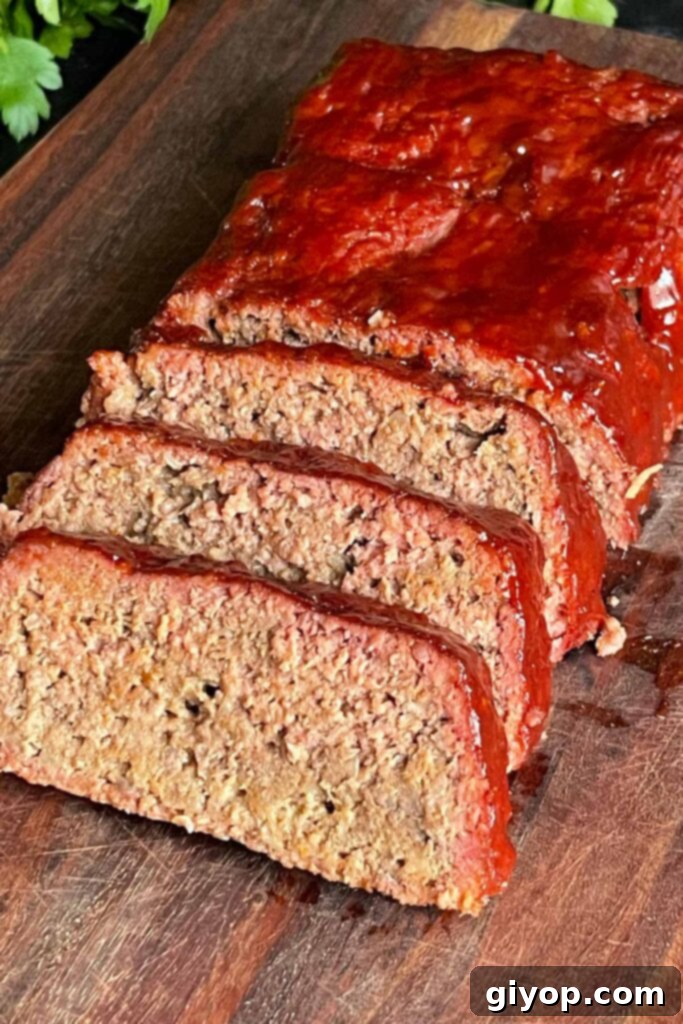 Slow-Smoked Meatloaf Masterpiece 11 smoked meatloaf on a cutting board sliced.