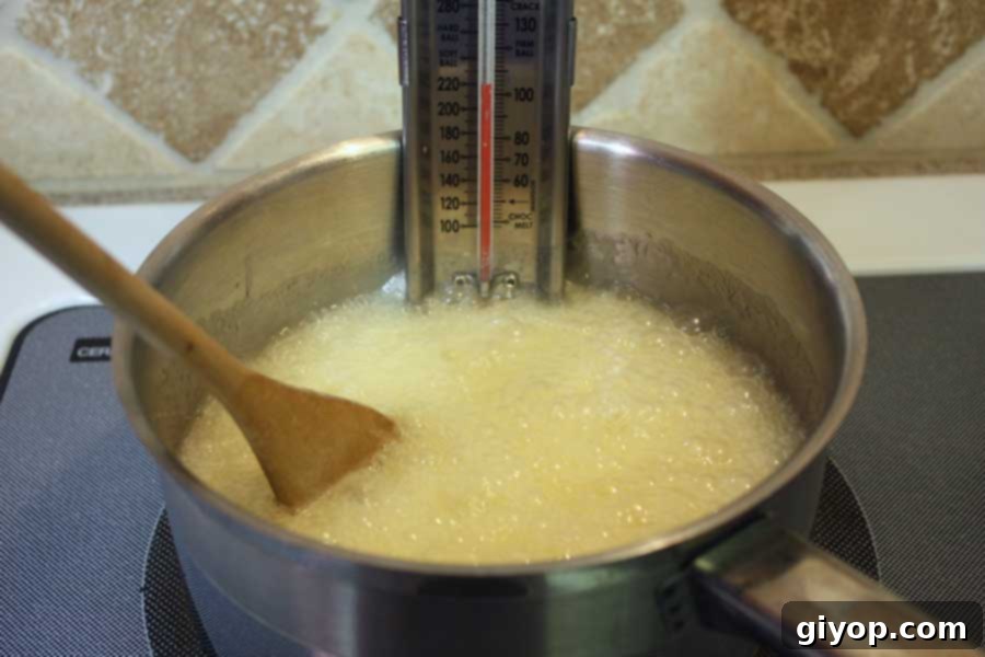 Butter, sugar, corn syrup, and water simmering in a saucepan for toffee.