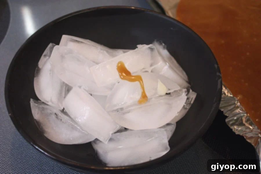 A small spoonful of cooked toffee mixture being tested in ice water.