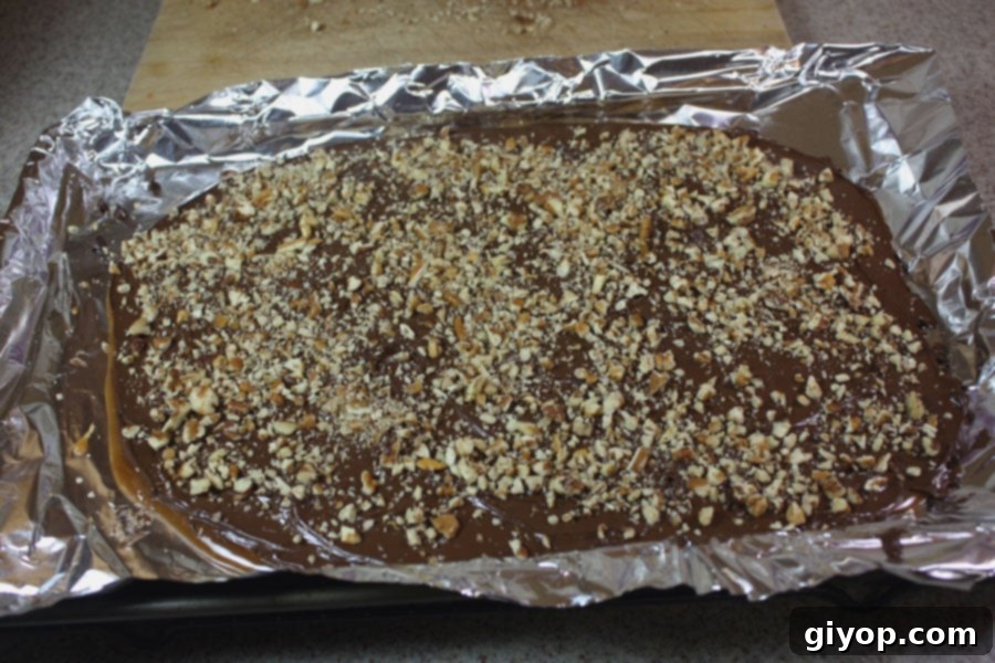 Freshly poured English toffee cooling on a foil-lined baking sheet.