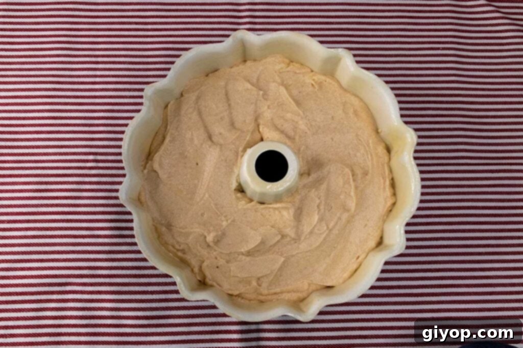 Cider-Glazed Apple Pound Cake 4 Apple cider pound cake batter smoothed into a classic bundt pan, ready for baking.