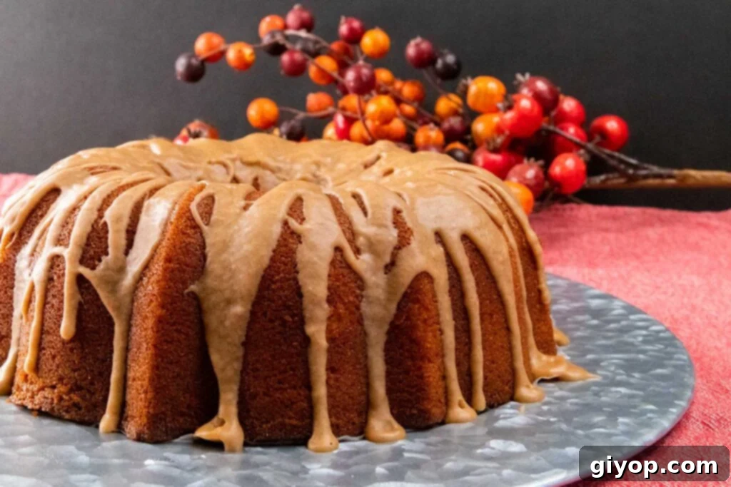 Cider-Glazed Apple Pound Cake 6 A beautifully glazed apple cider pound cake resting on a decorative silver charger, showcasing its rustic elegance.