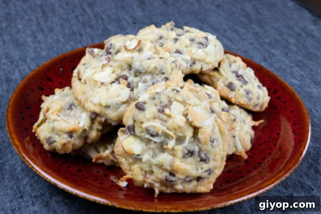 Delicious Almond Joy cookies arranged artfully on a vibrant red plate, showcasing their toasted coconut and chocolate chip topping.