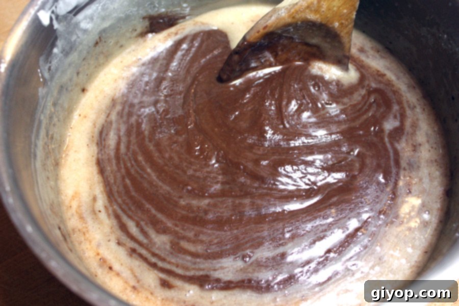 Decadent Easy Peppermint Fudge 3 Fudge ingredients cooking in a sauce pan.