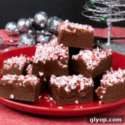 Decadent Easy Peppermint Fudge 6 Peppermint fudge slices on red plate.