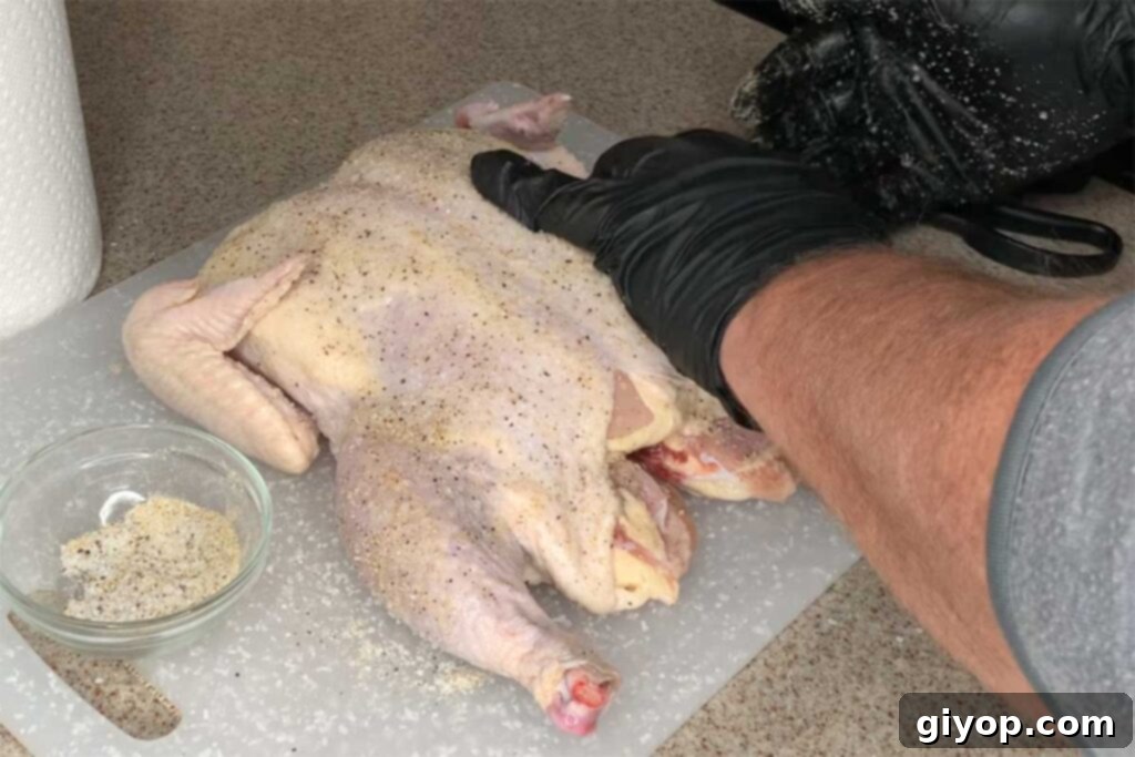 Adding a light rub to raw whole chicken before brining.