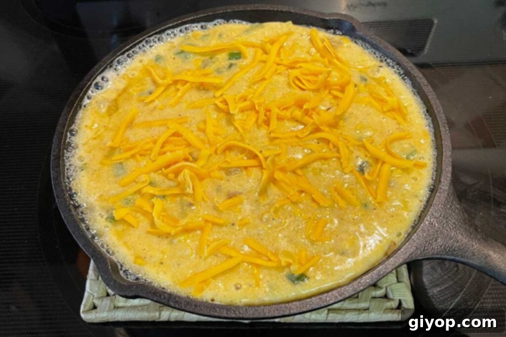 Uncooked cornbread in a cast iron skillet
