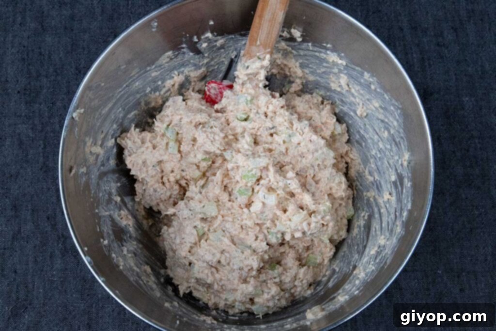 Smoked chicken salad, perfectly combined and glistening with dressing, showcased in a metal bowl.