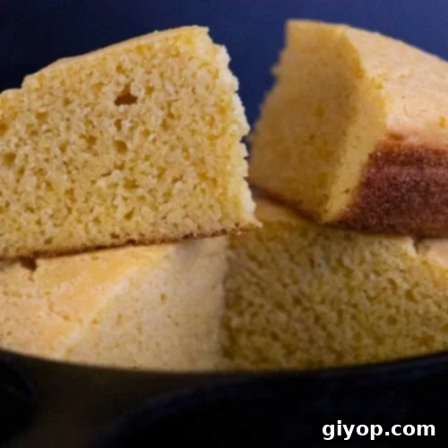 Slices of delicious buttermilk cornbread ready to be served from a cast iron skillet.