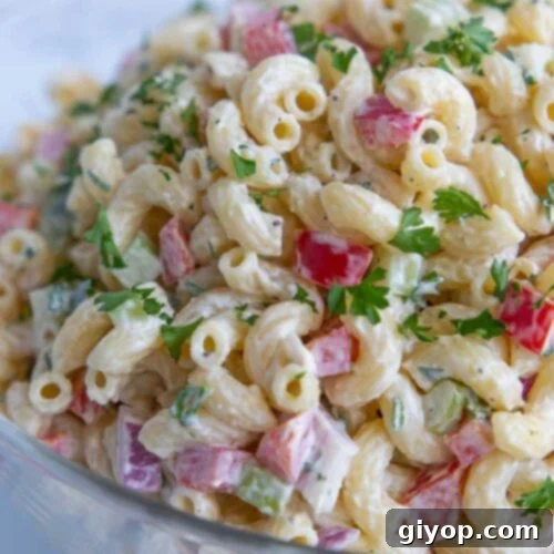 Macaroni salad in a glass bowl.