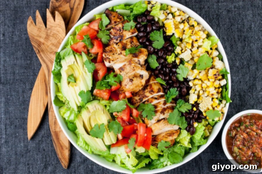 Southwest Grilled Chicken Salad - A fresh, healthy flavorful salad. Chicken marinated in a smoky adobo flavored marinade gives it more than just a "taco" flavor. Grilling the corn and jalapenos adds extra smoky flavor to this dish.