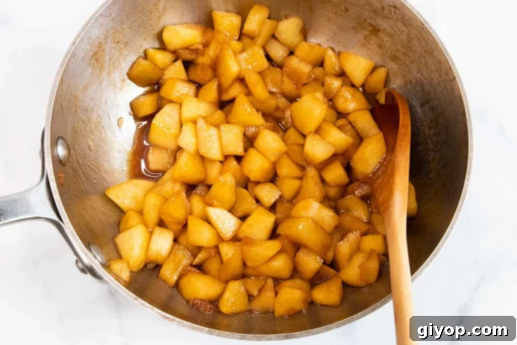 Chopped apples cooked in a saucepan.