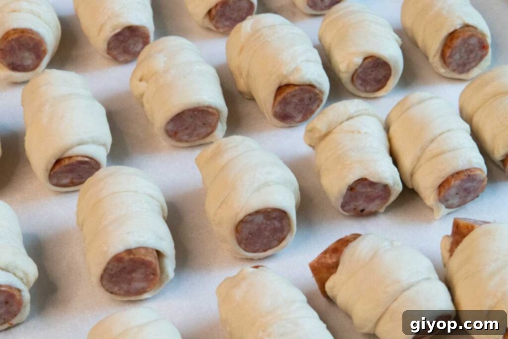Sausage pieces individually wrapped in strips of pizza dough.