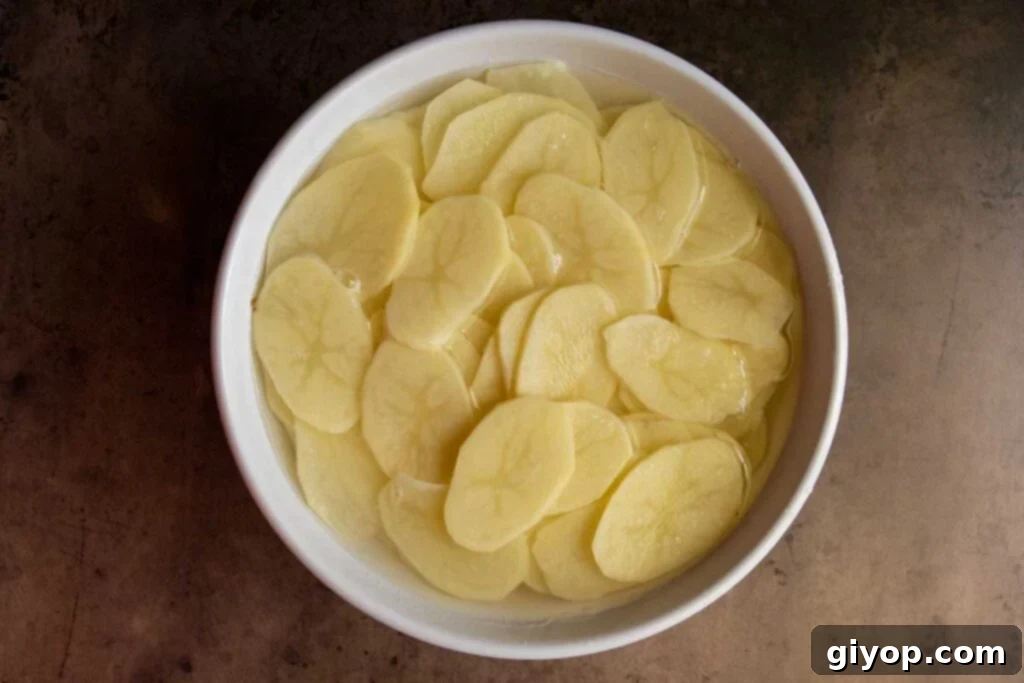 Sliced potatoes in water.