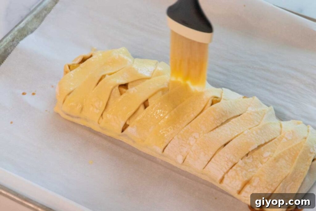 egg wash brushing over the pastry