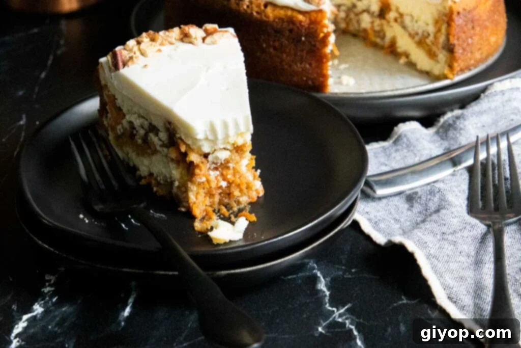 A fork taking a bite of the layered carrot cake cheesecake, showing the distinct layers.