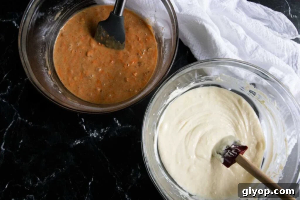 Cheesecake batter and carrot cake batter in separate glass mixing bowls, ready for layering.