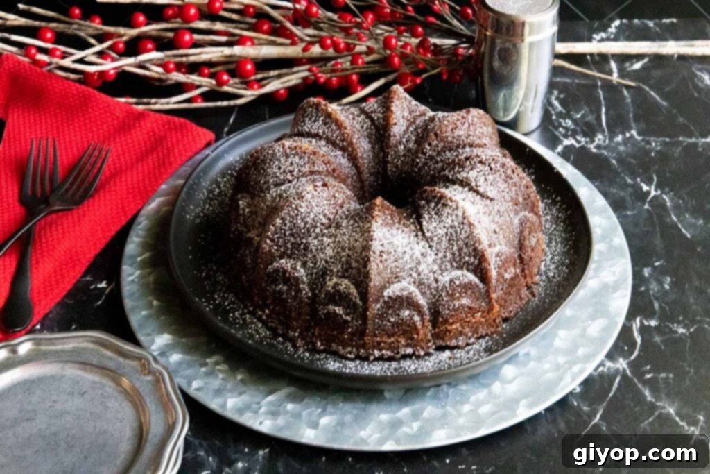Gramercy Tavern gingerbread on a black and silver platter, showing a perfectly baked, golden-brown exterior.