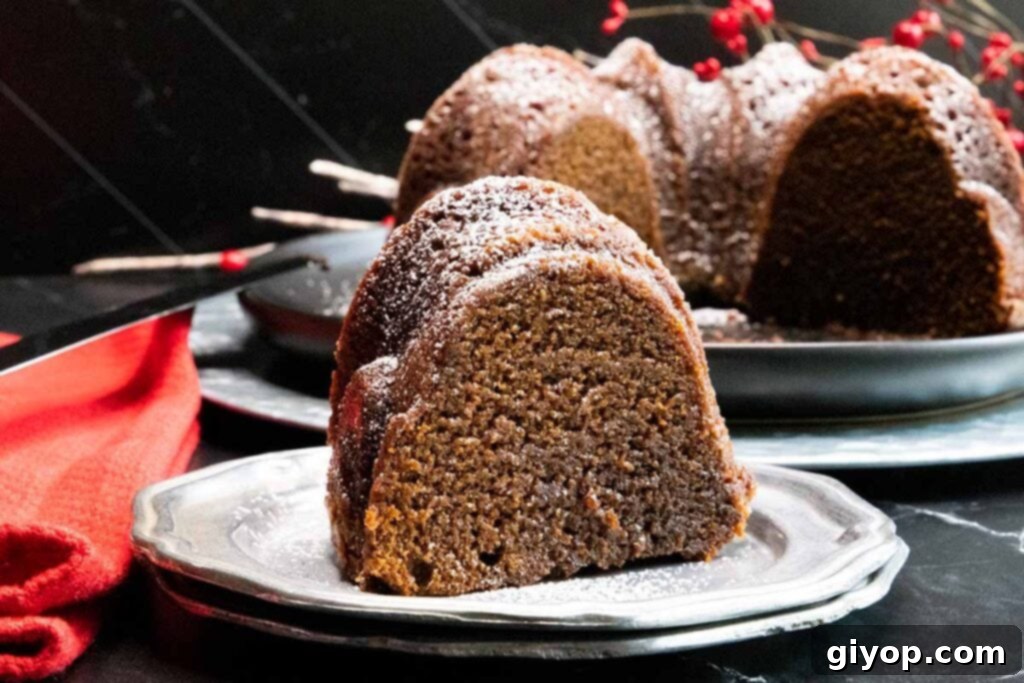 A perfectly sliced piece of Gramercy Tavern gingerbread, adorned with a dusting of powdered sugar, rests invitingly on a silver plate.