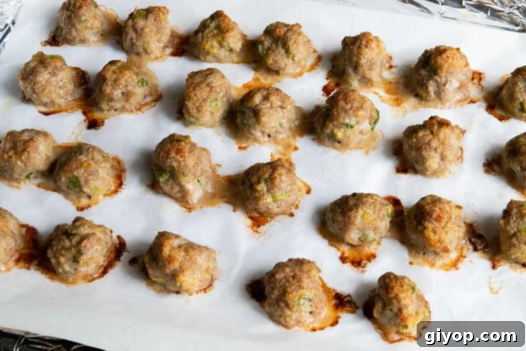 Golden-brown Asian meatballs freshly baked out of the oven, waiting to be coated in their delicious sauce.