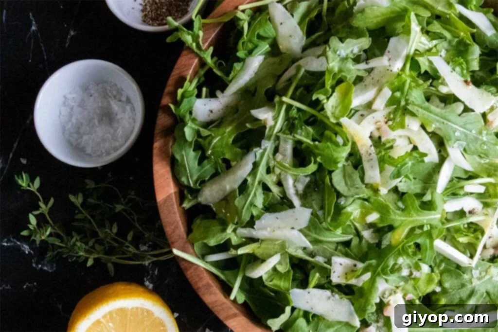 Zesty Arugula Fennel Medley 6 Another perspective of the arugula fennel salad in a wooden bowl, showing its fresh ingredients and inviting texture.
