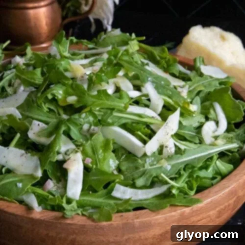 Zesty Arugula Fennel Medley 7 Arugula fennel salad in a wooden bowl.
