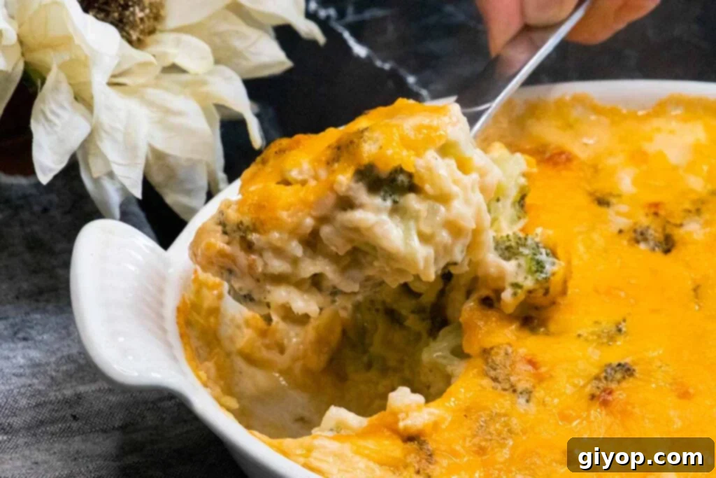 Broccoli rice casserole scooped onto a spoon, showing its cheesy, creamy texture ready to be enjoyed.