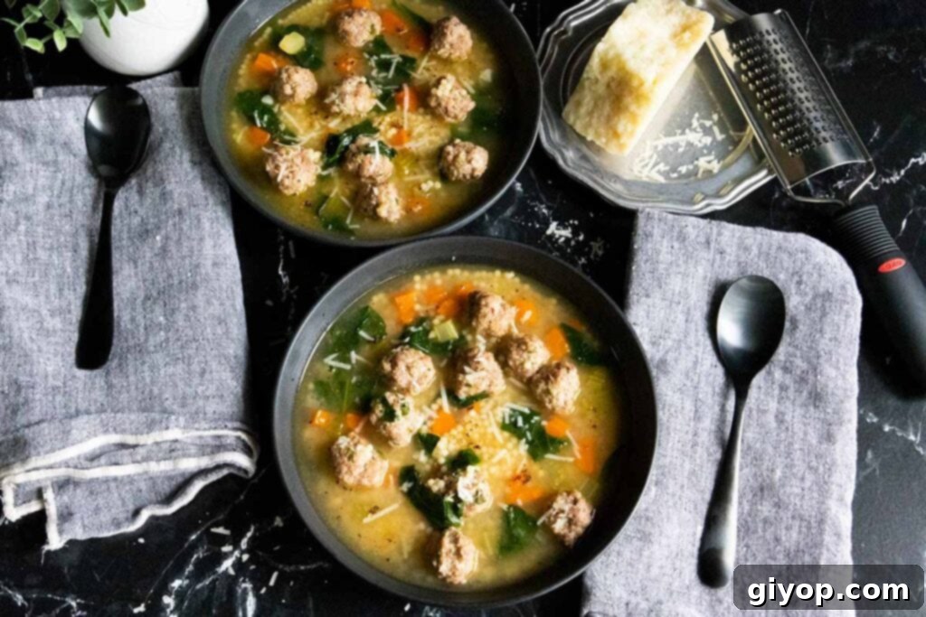 Italian wedding soup in black bowls.