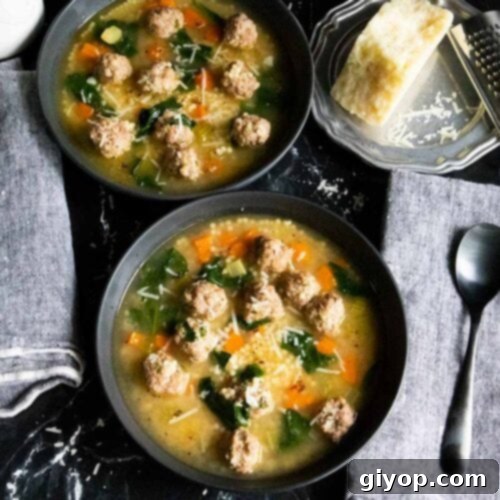 Italian wedding soup in black bowls.