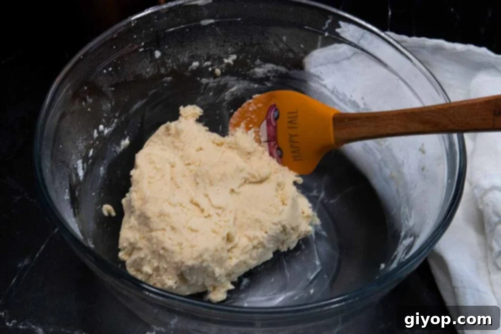 Maple Glazed Shortbread Perfection 3 Shortbread cookie dough in a clear glass mixing bowl, showcasing its smooth texture before chilling.