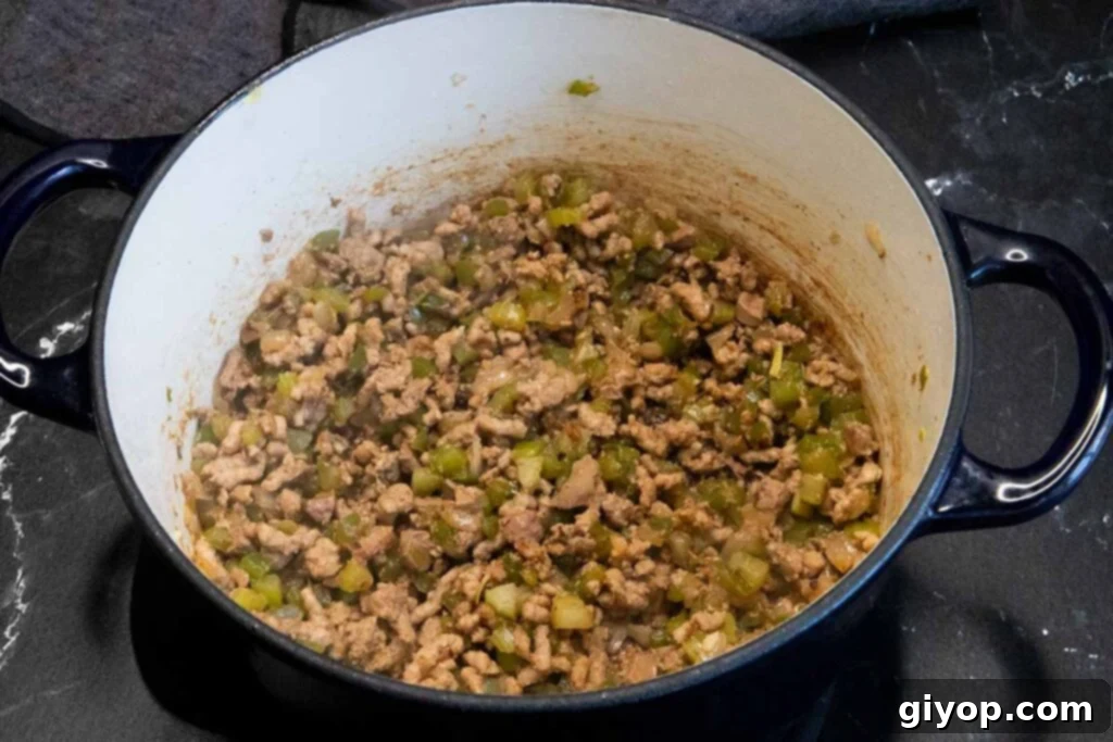 Crafting Perfect Cajun Dirty Rice 5 Meat mixture for cajun dirty rice cooked in a blue dutch oven