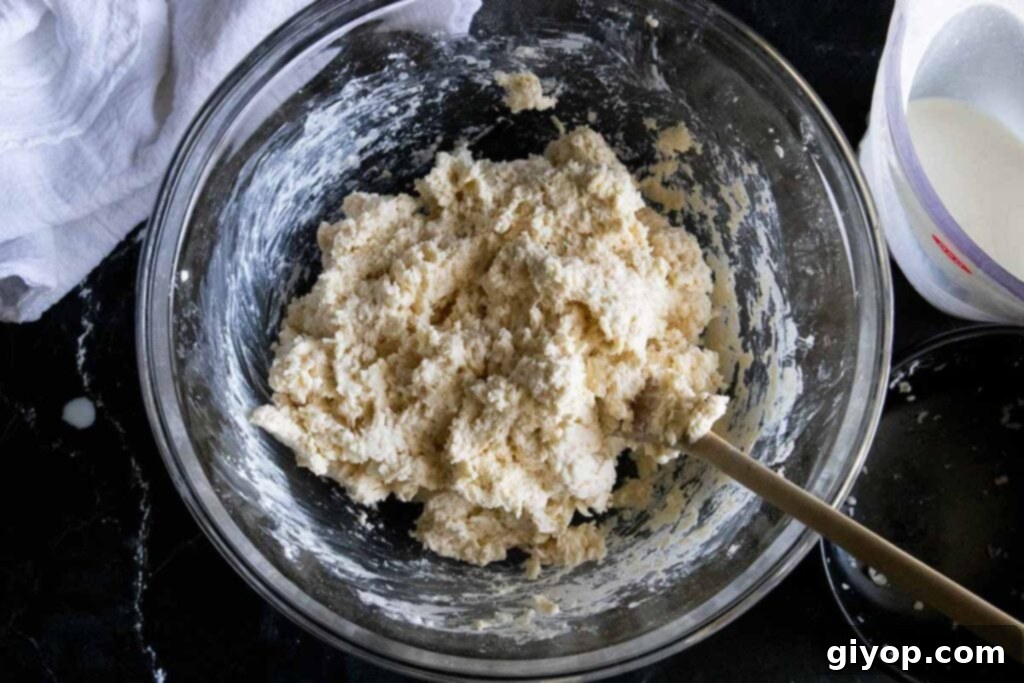 Biscuit dough in glass mixing bowl, just mixed to combine wet and dry ingredients.