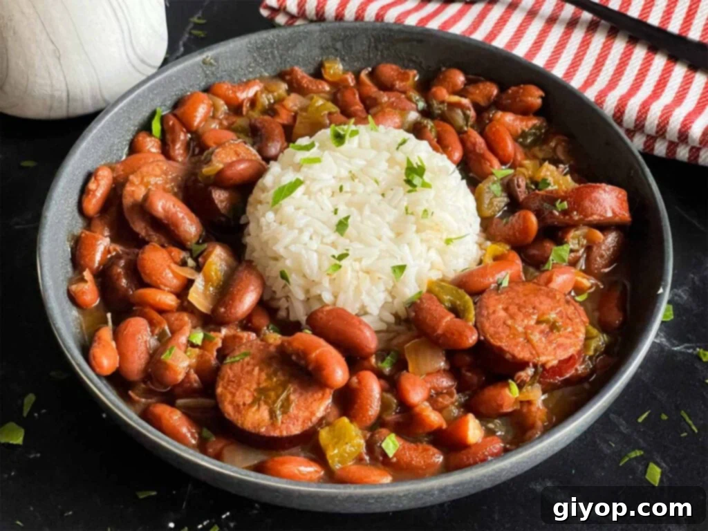 Soulful Slow Cooker Red Beans and Rice 2 Slow cooker red beans and rice in a dark bowl on a dark surface.