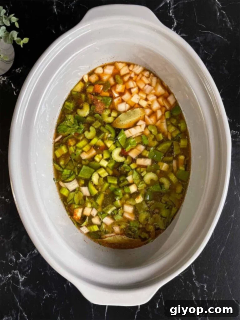Soulful Slow Cooker Red Beans and Rice 7 Chicken stock added to the red beans and rice ingredients in the crock of a slow cooker.