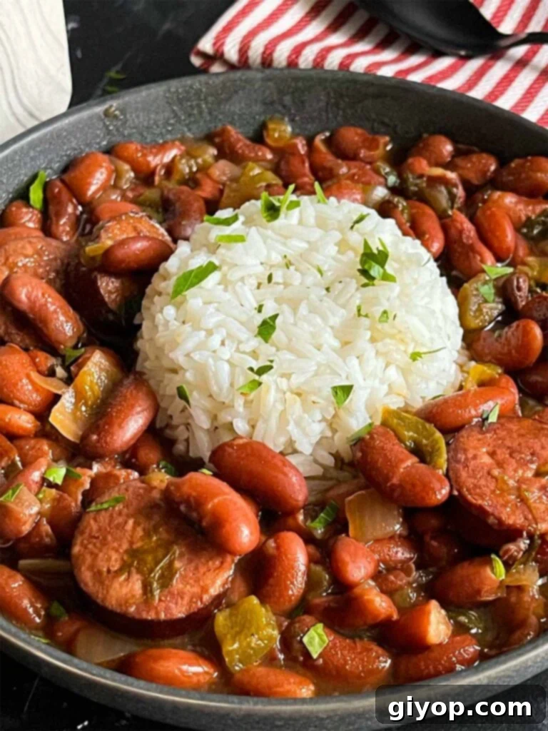 Soulful Slow Cooker Red Beans and Rice 9 Slow cooker red beans and rice in a dark bowl on a dark surface.