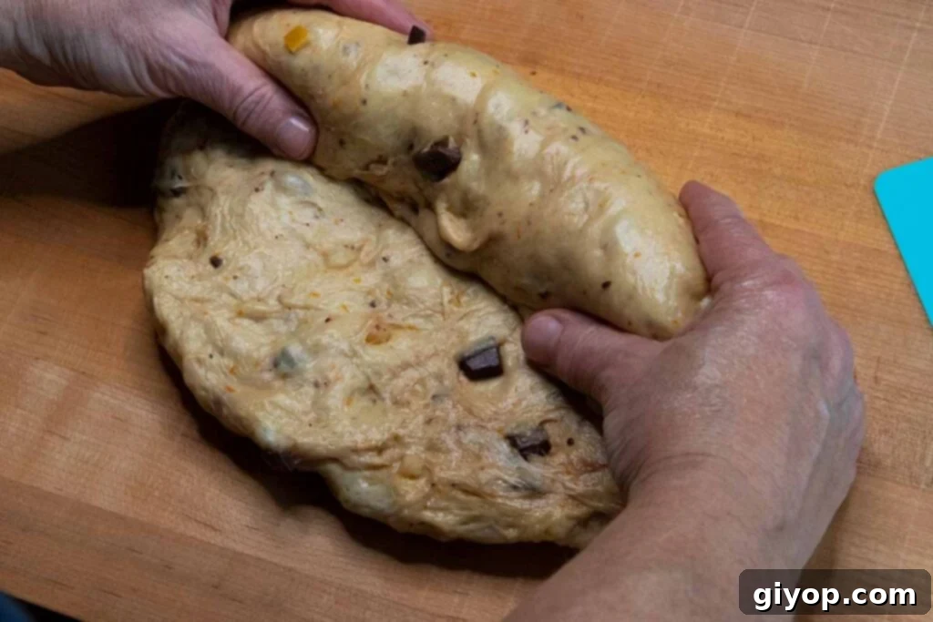 Decadent Chocolate Orange Panettone 12 Panettone dough being rolled into a log shape.
