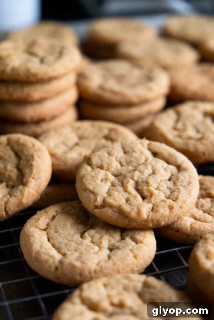 Stacked crunchy peanut butter cookies on a wire rack, ready to serve.