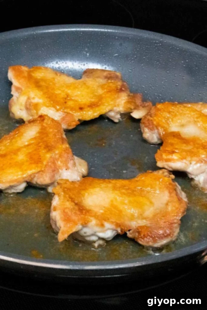 Sticky Crispy Teriyaki Chicken Thighs 6 Crispy, golden-brown chicken thighs cooked in a skillet.