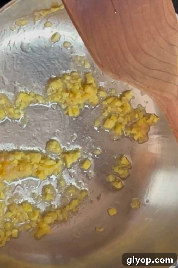 Sticky Crispy Teriyaki Chicken Thighs 7 Finely chopped ginger and garlic gently frying in a saucepan.