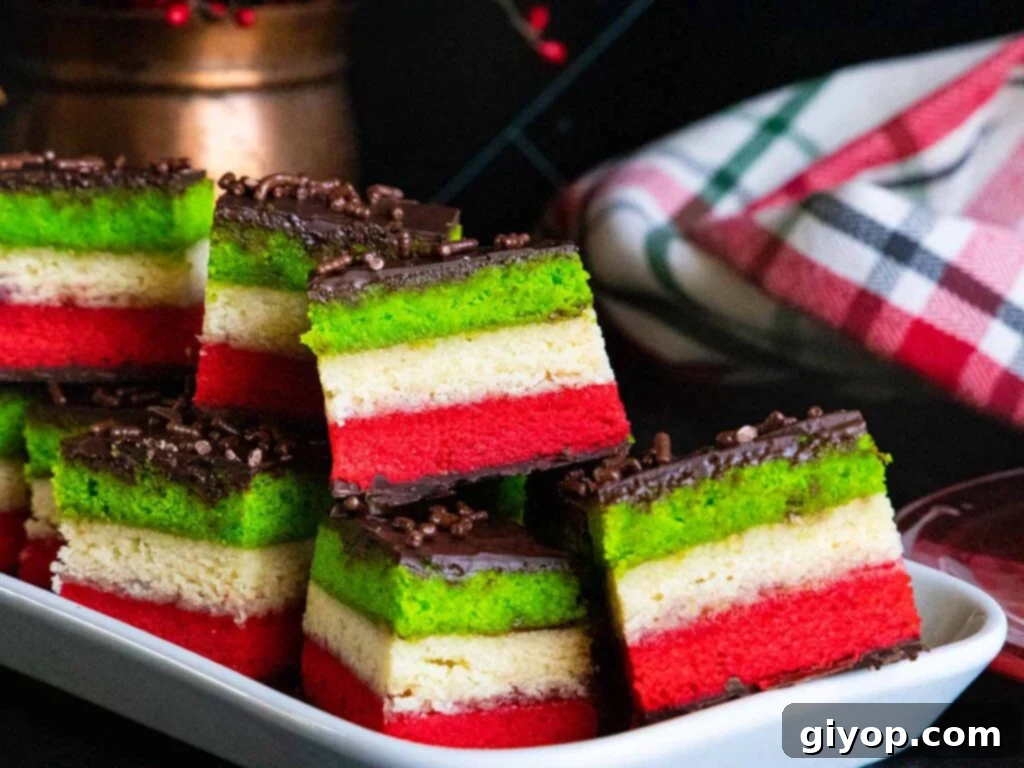 Italian rainbow cookies on a white tray.