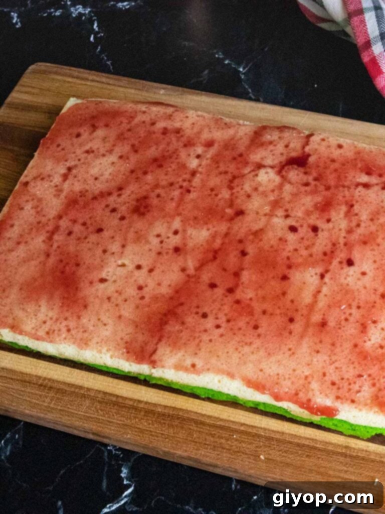 Raspberry jam spread over the white cookie layer.