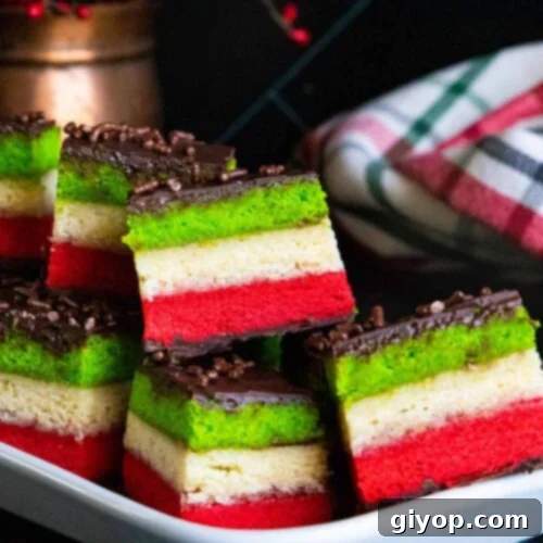 Italian rainbow cookies on a white tray.