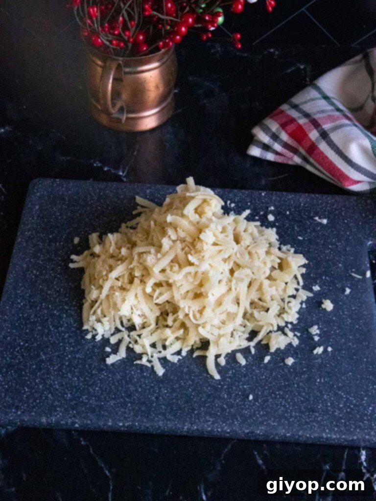 Shredded almond paste on a black cutting board.